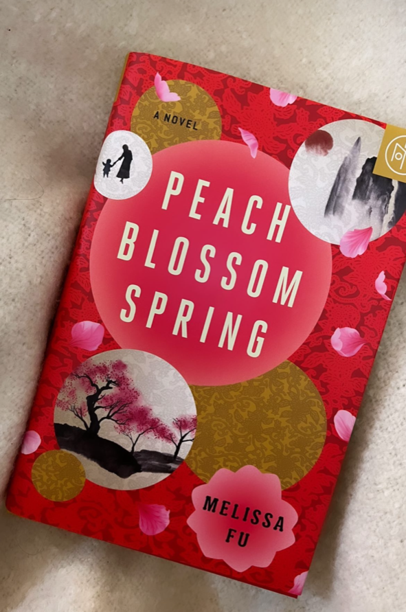 "Peach Blossom Spring" by Melissa Fu on a blanket.