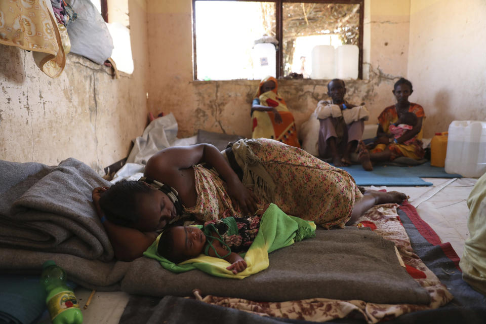 Image: Ethiopian refugees rest in Qadarif region, easter Sudan, Friday, Nov 20, 2020. Thousands of Ethiopians fled the war in Tigray region into Sudan. (Marwan Ali / AP)