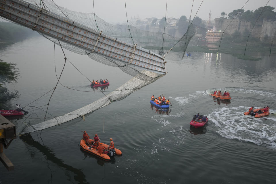 <p>Search and rescue work is going on as a cable suspension bridge collapsed in Morbi town of western state Gujarat, India, Monday, Oct. 31, 2022. The century-old cable suspension bridge collapsed into the river Sunday evening, sending hundreds plunging in the water, officials said. (AP Photo/Ajit Solanki)</p> 