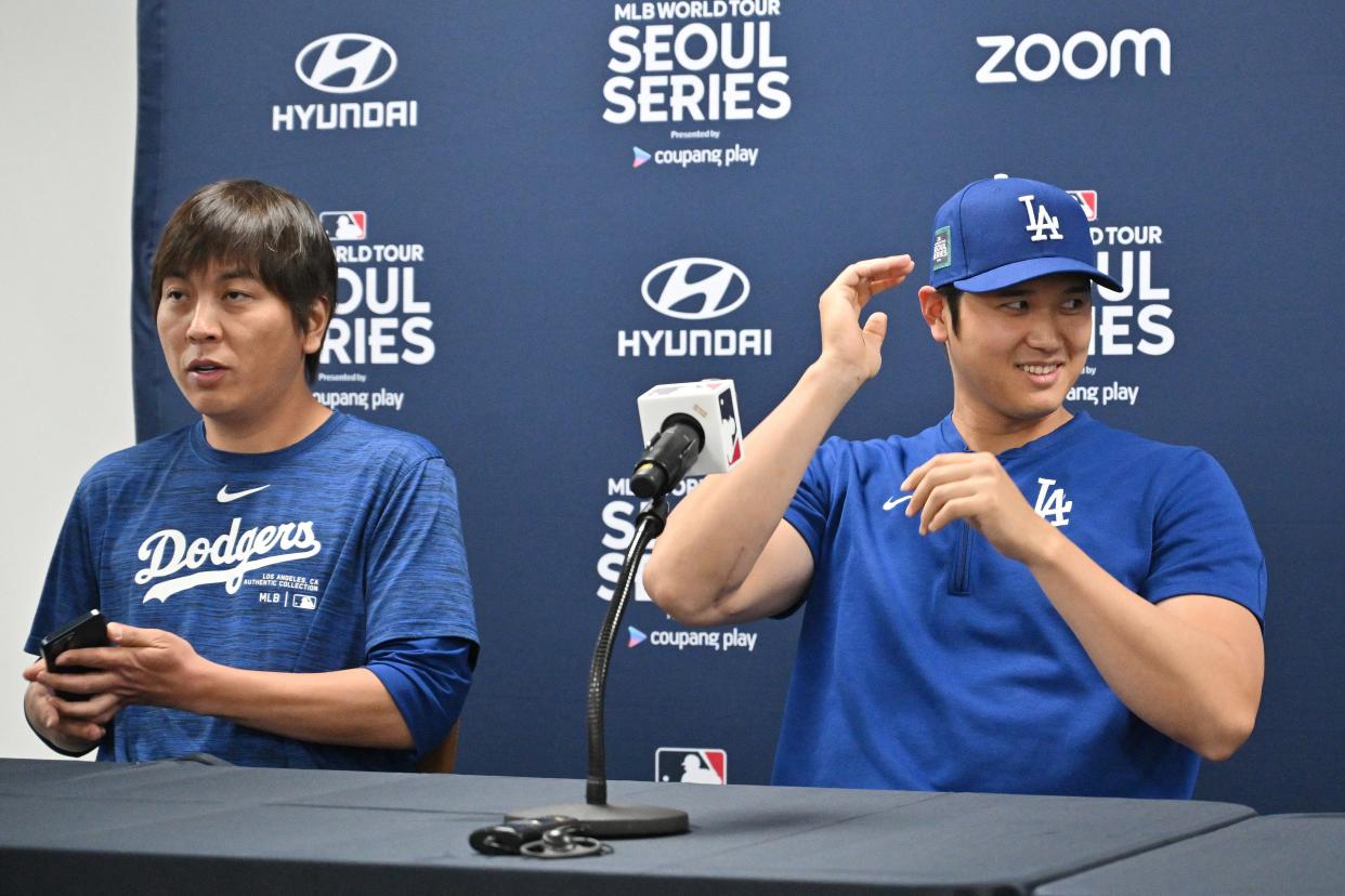 TOPSHOT - This picture taken on March 16, 2024 shows Los Angeles Dodgers' Shohei Ohtani (R) and his interpreter Ippei Mizuhara (L) attending a press conference at Gocheok Sky Dome in Seoul ahead of the 2024 MLB Seoul Series baseball game between Los Angeles Dodgers and San Diego Padres. The Los Angeles Dodgers said on March 21 they had fired Shohei Ohtani's interpreter after the Japanese baseball star's representatives claimed he had been the victim of "a massive theft" reported to involve millions of dollars. (Photo by Jung Yeon-je / AFP) (Photo by JUNG YEON-JE/AFP via Getty Images)