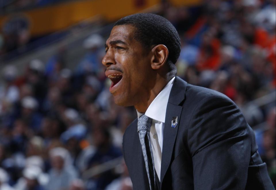 Connecticut coach Kevin Ollie calls out to his team during the first half of a third-round game against Villanova in the NCAA men's college basketball tournament in Buffalo, N.Y., Saturday, March 22, 2014. (AP Photo/Bill Wippert)