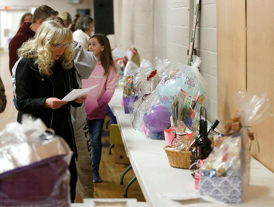 Guests check out the baskets for auction at Friday's Relay For Life of Ashland County-Mid Ohio chili cook-off.