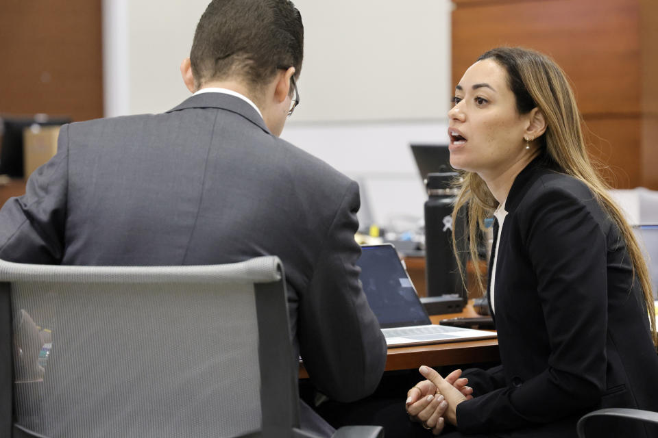 Legal assistant Aaron Savitski and Assistant State Attorney Kristen Gomes speak during a break in the trial of former Marjory Stoneman Douglas High School School Resource Officer Scot Peterson at the Broward County Courthouse in Fort Lauderdale on Tuesday, June 20, 2023. Broward County prosecutors charged Peterson, a former Broward Sheriff's Office deputy, with criminal charges for failing to enter the 1200 Building at the school and confront the shooter as he perpetuated the Valentine's Day 2018 Massacre that left 17 dead and 17 injured. (Amy Beth Bennett/South Florida Sun-Sentinel via AP, Pool)