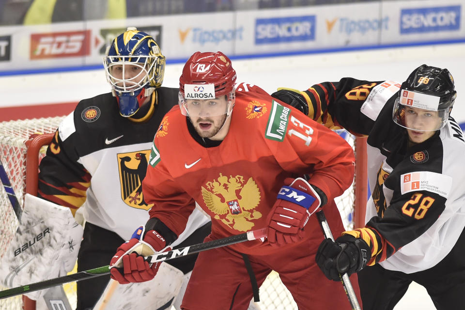 Goalkeeper Tobias Ancicka, left, and Eric Mik, right, of Germany and Yegor Sokolov of Russia during the 2020 IIHF World Junior Ice Hockey Championships Group B match between Russia and Germany in Ostrava, Czech Republic, on Tuesday Dec. 31, 2019. (Jaroslav Ozana/CTK via AP)