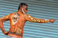 <p>A fan of Indian Bollywood star Rajinikanth displays body paint with a portrait of the actor on the first day of release of his new Tamil-language film “Kabali” in Bangalore on July 22, 2016. Fans of the wildly popular Indian film star Rajinikanth queued overnight for a 4am screening of his eagerly awaited new movie on July 22 in the southern city of Chennai, where many companies gave up all hope of staff showing up for work and closed for the day. Rajinikanth famously worked as a bus conductor in the southern Indian city of Bangalore before heading to Chennai in 1973 to pursue his passion of acting. </p>