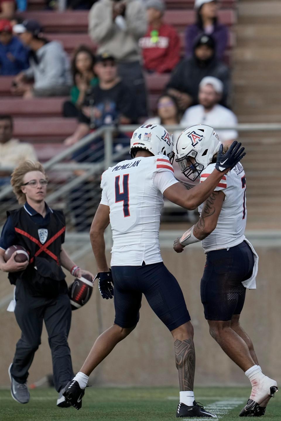 Arizona quarterback Jayden de Laura, right, celebrates with wide receiver Tetairoa McMillan (4) after scoring a rushing touchdown against Stanford during the second half of an NCAA college football game Saturday, Sept. 23, 2023, in Stanford, Calif. (AP Photo/Godofredo A. Vásquez)