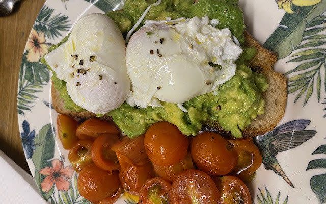 An example of Rani's breakfast now, consisting of poached eggs and avocado on toast with tomatoes