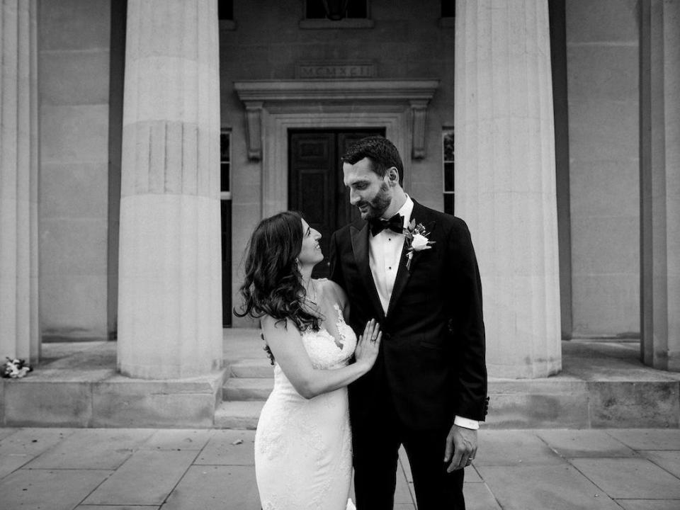 A black-and-white photo of a bride and groom on their wedding day.