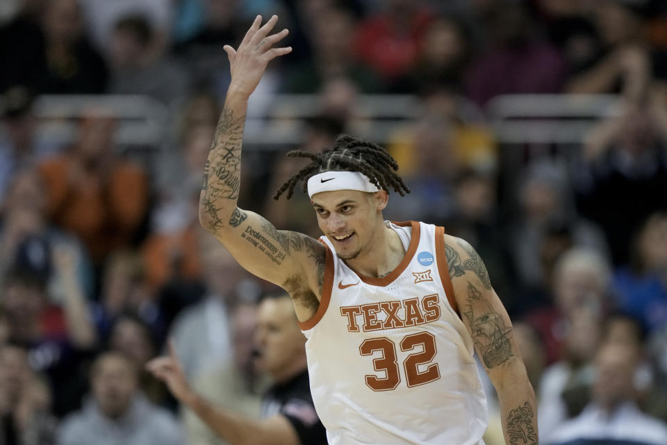 Texas forward Christian Bishop celebrates after scoring in the first half of a Sweet 16 college basketball game against Xavier in the Midwest Regional of the NCAA Tournament Friday, March 24, 2023, in Kansas City, Mo. (AP Photo/Charlie Riedel)