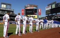 <p>Members of the New York Mets stand for a moment of silence in honor of for Jose Fernandez of the Miami Marlins prior to taking on the Philadelphia Phillies at Citi Field on September 25, 2016 in the Flushing neighborhood of the Queens borough of New York City. Fernandez died earlier in the day in a boating accident. (Photo by Adam Hunger/Getty Images) </p>