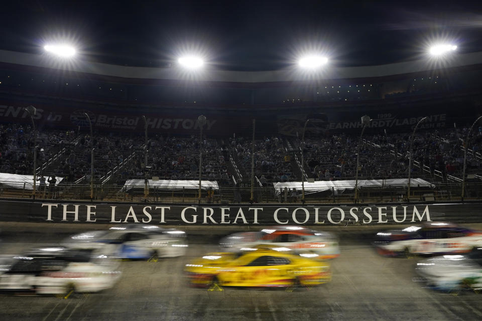 Drivers come through a turn during a NASCAR Cup Series auto race at Bristol Motor Speedway Saturday, Sept. 17, 2022, in Bristol, Tenn. (AP Photo/Mark Humphrey)