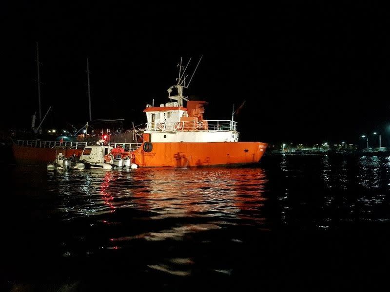 A Turkish Coast Guard Command boat is seen next to cargo ship during a raid in Izmir