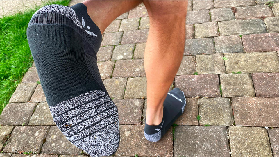 Man wearing Swiftwick Flite XT Zero Tab trail running socks