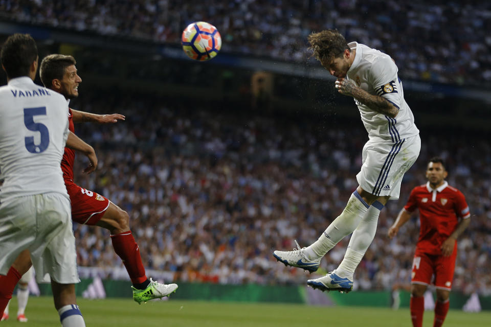 <p>Real Madrid’s Sergio Ramos, top, goes for a header during the La Liga soccer match between Real Madrid and Sevilla at the Santiago Bernabeu stadium in Madrid, Sunday, May 14, 2017. (Photo: Francisco Seco/AP) </p>