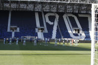 Players observe a minute of silence to honor the victims of coronavirus, prior to the Serie A soccer match between Atalanta and Sassuolo at the Gewiss Stadium in Bergamo, Italy, Sunday, June 21, 2020. Atalanta is playing its first match in Bergamo since easing of lockdown measures, in the area that has been the epicenter of the hardest-hit province of Italy's hardest-hit region, Lombardy, the site of hundreds of COVID-19 deaths. (AP Photo/Luca Bruno)