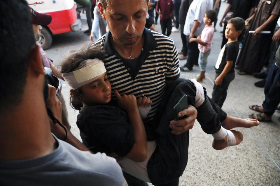 A Palestinian child wounded in an Israeli bombardment on a residential building owned by the Jabr family in Bureij refugee camp, is brought to al-Aqsa Martyrs Hospital in Deir al Balah, central Gaza Strip, Wednesday, June 12, 2024. (AP Photo/Saher Alghorra)