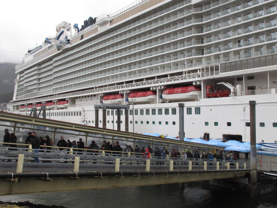 Passengers stream off the Norwegian Bliss after the vessel arrived in Juneau, Alaska on Monday, April 25, 2022. It is the first large cruise ship of the season to arrive in Alaska. (AP Photo/Becky Bohrer)