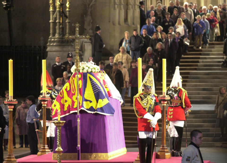 Mourners filing past the coffin of The Queen Mother, in Westminster Hall, London, where she was lying in state before her funeral in 2002. (PA)