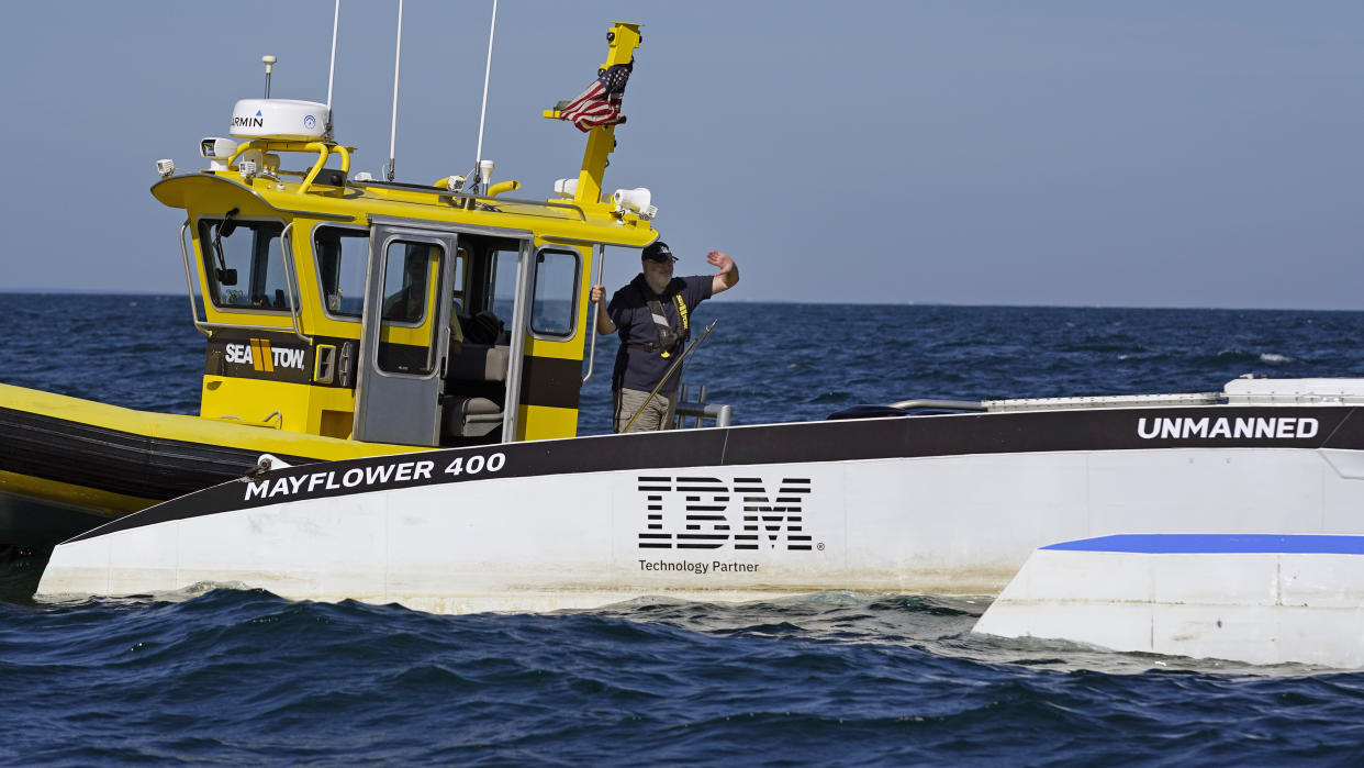 Brett Phaneuf, co-director of the Mayflower Autonomous Ship project, waves to the sport team over streaming cameras aboard the Mayflower Autonomous Ship , Thursday, June 30, 2022, off the coast of Plymouth, Mass., after a crew-less journey from Plymouth, England. (AP Photo/Charles Krupa)