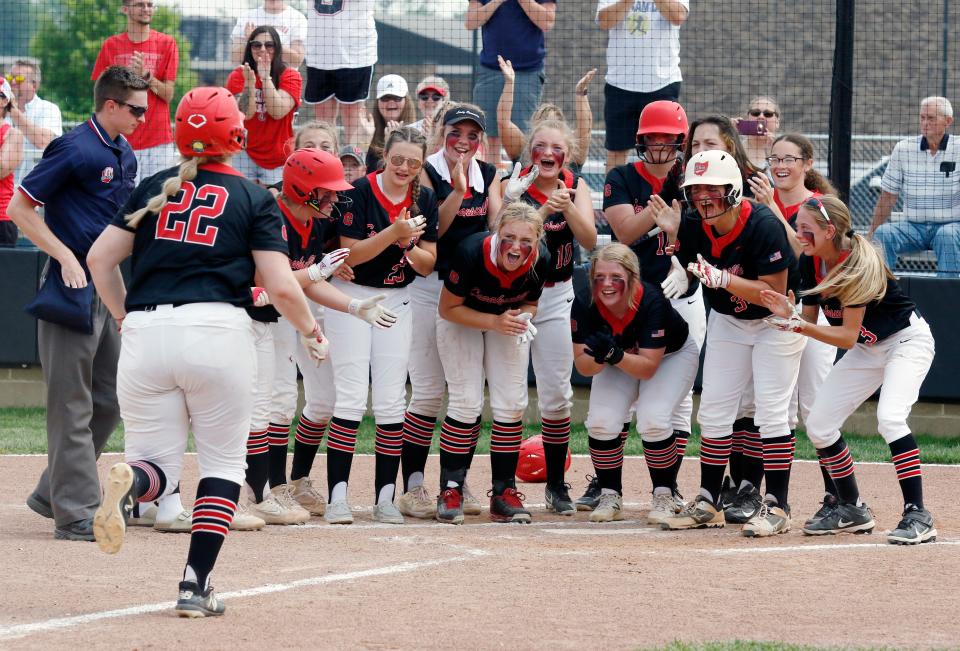 Teammates wait for senior Grace Frame at home plate after she hit a grand slam in the third inning of Crooksville's 12-0 win against Portsmouth in a Division III district final on May 21, 2022, at Unioto High School in Chillicothe. Frame had a team-high three hits as the Ceramics reached their first regional since 2012.