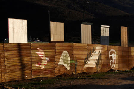 Prototypes for U.S. President Donald Trump's border wall with Mexico are seen behind the current border fence in this picture taken from the Mexican side of the border in Tijuana, Mexico, January 27, 2018. REUTERS/Jorge Duenes