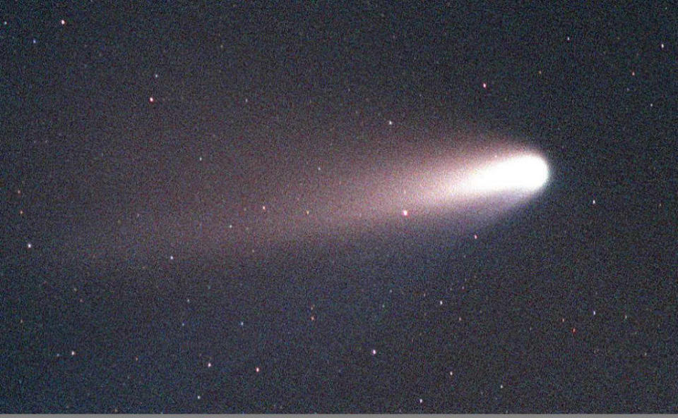 KENNEDY SPACE CENTER, FL - MARCH 10:  The comet Hale-Bopp appears in the sky over Merrit Island, Florida, early 10 March, south of the Kennedy Space Center. The comet can be seen from late March to the beginning of April, before disappearing for the next 2,400 years. The comet is an occasional visitor from the outer solar system.***THIS AND KSC01 ARE VERTICAL PICTURES. ROTATE 90CW***  (Photo credit should read GEORGE SHELTON/AFP/Getty Images)