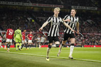 Newcastle's Anthony Gordon celebrates after scoring his side's opening goal during the English Premier League soccer match between Manchester United and Newcastle United, in Manchester, England, Wednesday, May 15, 2024. (AP Photo/Dave Thompson)