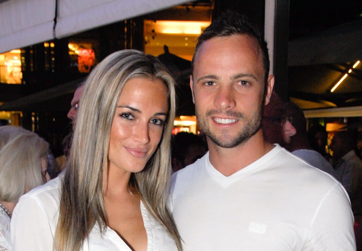 Reeva Steenkamp (left) with Pistorius less than a month before her death (AFP via Getty Images)