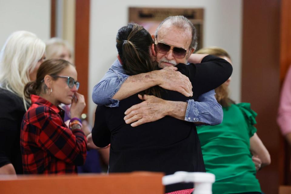 Larry Woodcock, the grandfather of slain JJ Vallow, gets a hug after the verdict in the Chad Daybell murder trial was read at the Ada County Courthouse in Boise, Idaho, on May 30, 2024 (AP)