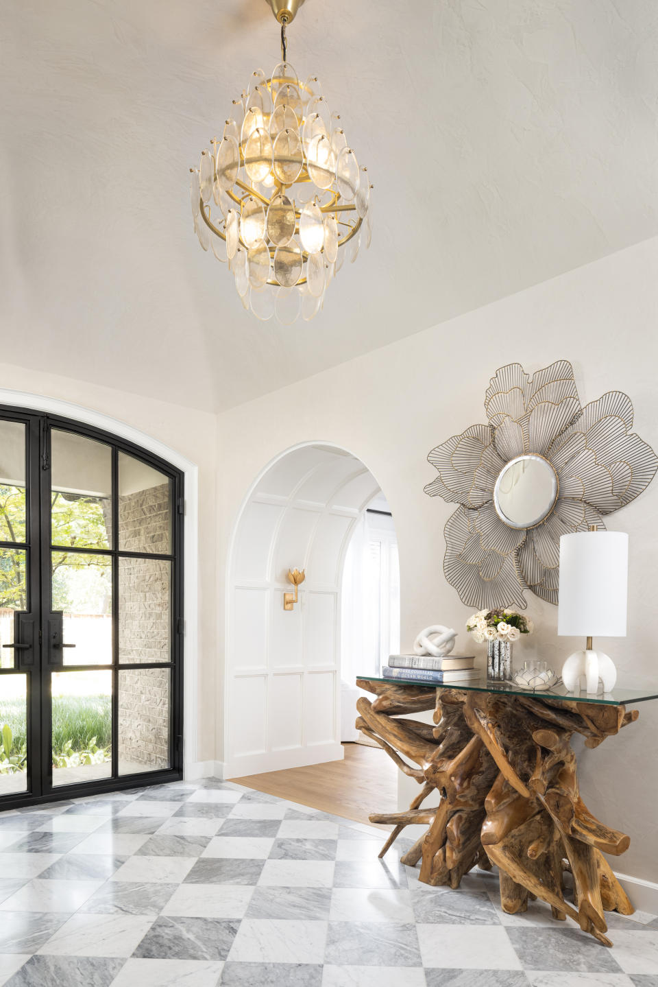 hallway with tall vaulted ceilings and chandelier