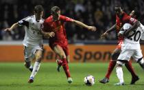 Swansea City's Ben Davies (L) challenges Liverpool's Jordan Henderson (2nd L) as Swansea City's Jonathan De Guzman (R) gets into a tussle with Liverpool's Andre Wisdom during their English Premier League soccer match at the Liberty Stadium in Swansea, Wales September 16, 2013.