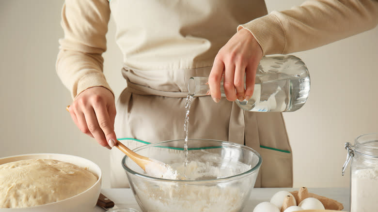 adding water to bread dough