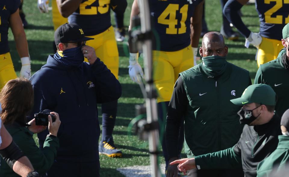 Michigan Wolverines coach Jim Harbaugh and Michigan State Spartans coach Mel Tucker walk off the field after MSU's 27-24 win at Michigan Stadium in Ann Arbor, Saturday, Oct. 31, 2020.