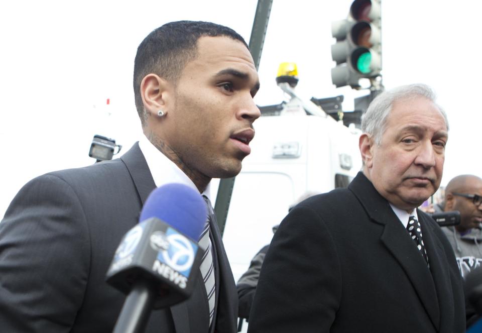 Singer Chris Brown, left, arrives at the District of Columbia Superior Court in Washington, Wednesday, Jan. 8, 2014, with his lawyer, for a status hearing in a case in which he's accused of hitting a man outside a Washington hotel. The R&B singer was arrested in October after a man said the singer hit him outside the W Hotel. Brown and his bodyguard each face a misdemeanor assault charge. (AP Photo/Manuel Balce Ceneta)