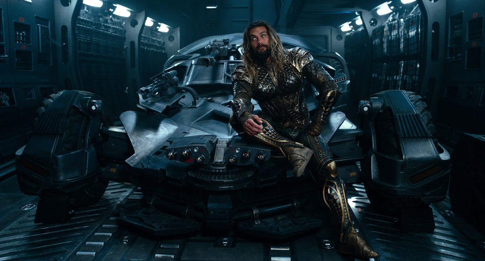 Jason Momoa sits atop the Batmobile in ‘Justice League’ (Warner Bros.)