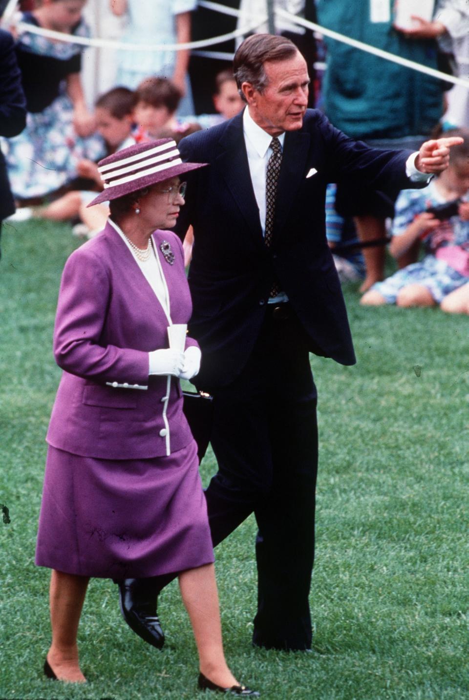 <p>Her Majesty met President Bush in a no-nonsense purple skirt suit.<br><i>[Photo: PA]</i> </p>