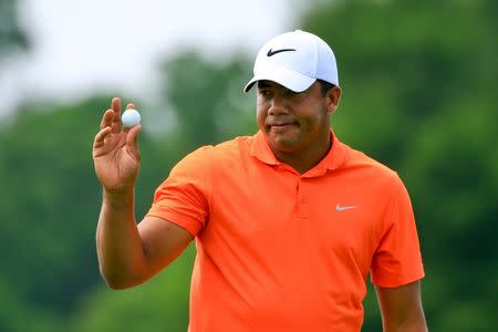Apr 29, 2016; Avondale, LA, USA; Jhonattan Vegas waves to the crowd after completing the 18th hole during the continuation of the first round following weather delays for the 2016 Zurich Classic of New Orleans at TPC Louisiana. Mandatory Credit: Derick E. Hingle-USA TODAY Sports