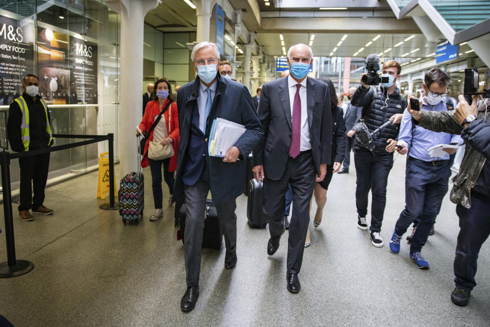 EU's chief negotiator Michel Barnier, centre left, walks with EU Ambassador to the UK, Portuguese diplomat Joao Vale de Almeida after arriving at St Pancras International railway station, in London, Wednesday, Sept. 9, 2020. UK and EU officials are set to begin the eighth round of Brexit negotiations in London. (Aaron Chown/PA via AP)