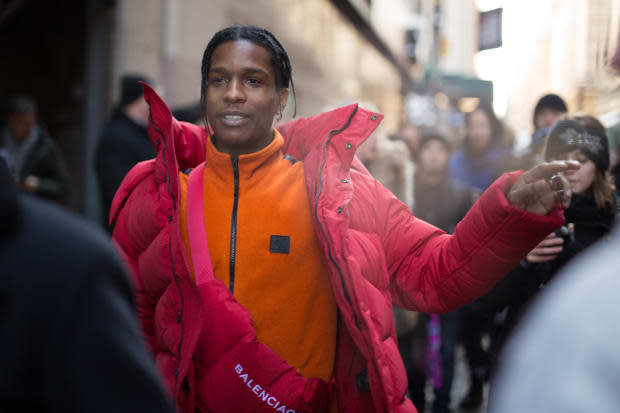 A$AP Rocky <em>wearing an orange Calvin Klein fleece </em>at Calvin Klein's Fall 2017 show during New York Fashion Week. 