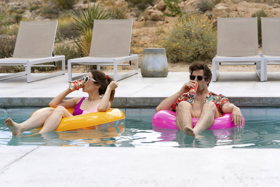 This image released by Hulu shows Cristin Milioti, left, and Andy Samberg in a scene from the film "Palm Springs." (Jessica Perez/Hulu via AP)