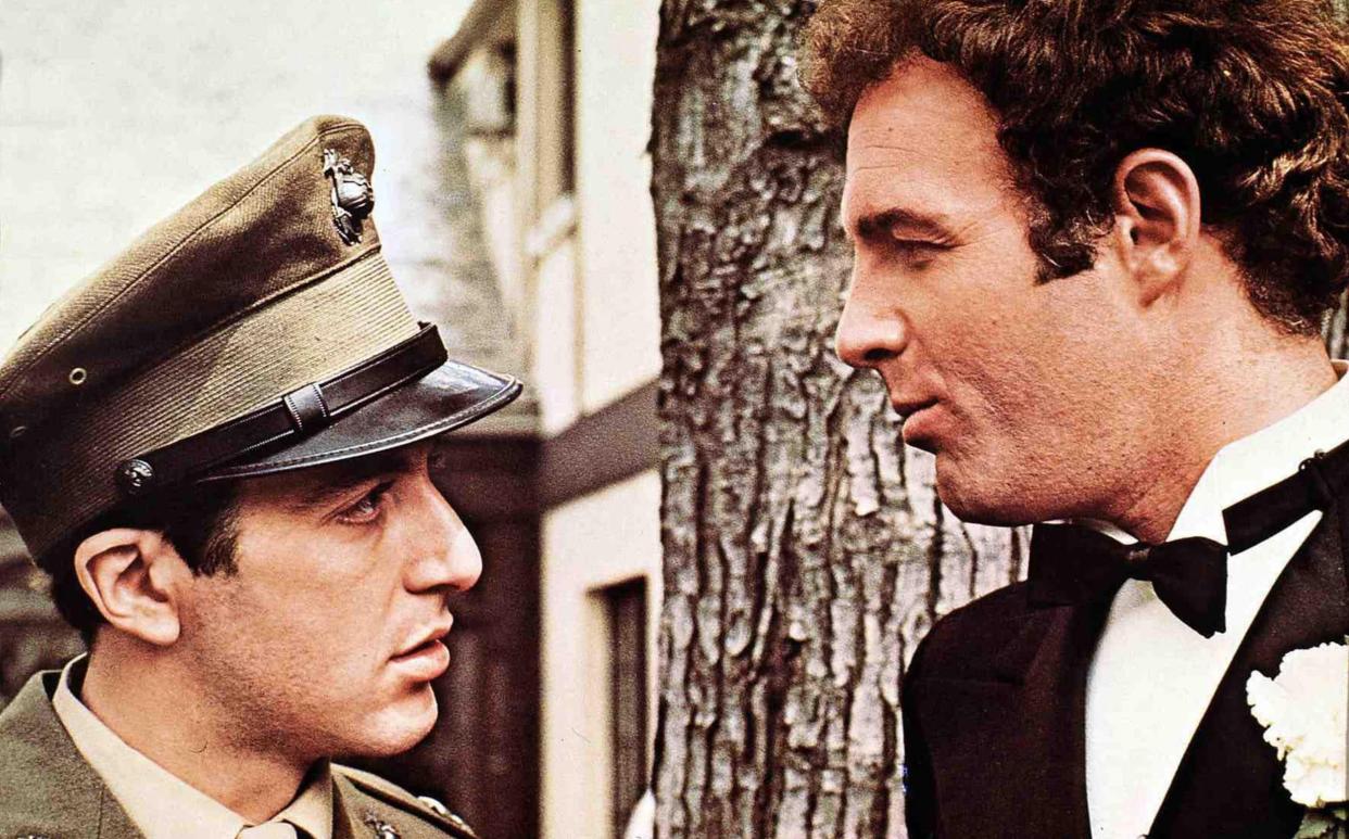 Caan, right, as the hotheaded Sonny with Al Pacino as his brother Michael Corleone in The Godfather (1972) - alamy