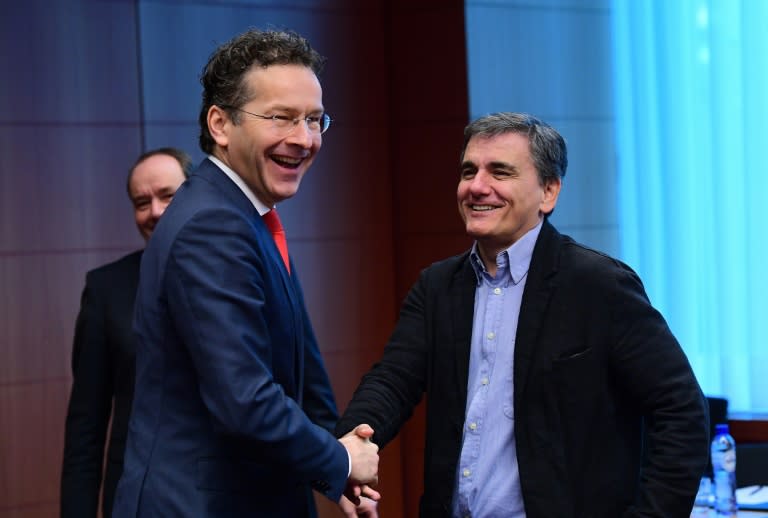 Eurogroup President and Dutch Finance Minister Jeroen Dijsselbloem (L) and Greece's Finance Minister Euclid Tsakalotos speak together ahead of a Eurogroup finance ministers meeting at the European Council in Brussels, on December 5, 2016