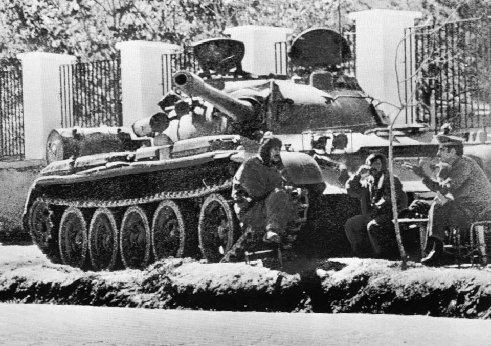 FILE - Tank crewmen bask in the sunshine beside their Soviet-made tank after taking station outside the Soviet Embassy in Kabul, Afghanistan, May 3, 1978. The former Soviet Union marched into Afghanistan on Christmas Eve, 1979, claiming it was invited by the new Afghan communist leader, Babrak Karmal, setting the country on a path of 40 years of seemingly endless wars and conflict. After the Soviets left in humiliation, America was the next great power to wade in. (AP Photo, File)