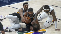 Sacramento Kings forward Maurice Harkless, center, battle for the ball against Utah Jazz's Donovan Mitchell, left, and Royce O'Neale (23) in the first half during an NBA basketball game Saturday, April 10, 2021, in Salt Lake City. (AP Photo/Rick Bowmer)