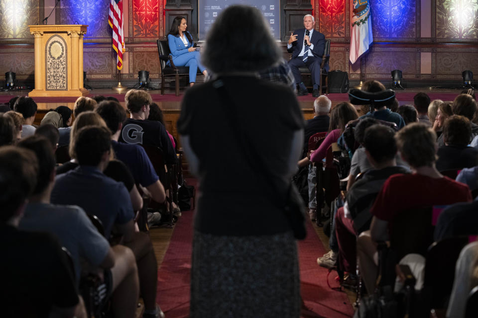 A student asks a question of Republican presidential candidate and former Vice President Mike Pence, right, next to AP National Politics Reporter Meg Kinnard, left, moderating, Tuesday, Oct. 3, 2023, during an Associated Press 2024 GOP Presidential Candidates Conversations on National Security and Foreign Policy event, held in partnership with Georgetown University's Institute of Politics and Public Service, at Georgetown University in Washington. (AP Photo/Jacquelyn Martin)