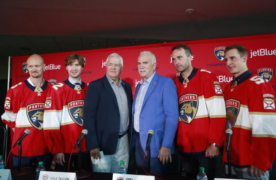 FILE - In this July 2, 2019, file photo, Florida Panthers President of Hockey Operations & General Manager Dale Tallon, third from left, and head coach Joel Quenneville, third from right, pose with new players Anton Stralman, left, Sergei Bobrovsky, second from left, Brett Connolly, second from right, and Noel Acciari, right, after a news conference in Sunrise, Fla. With Tampa Bay, Boston, the Toronto Maple Leafs and refueled Florida Panthers, the Atlantic Division looks like murderer’s row. (AP Photo/Wilfredo Lee, File)