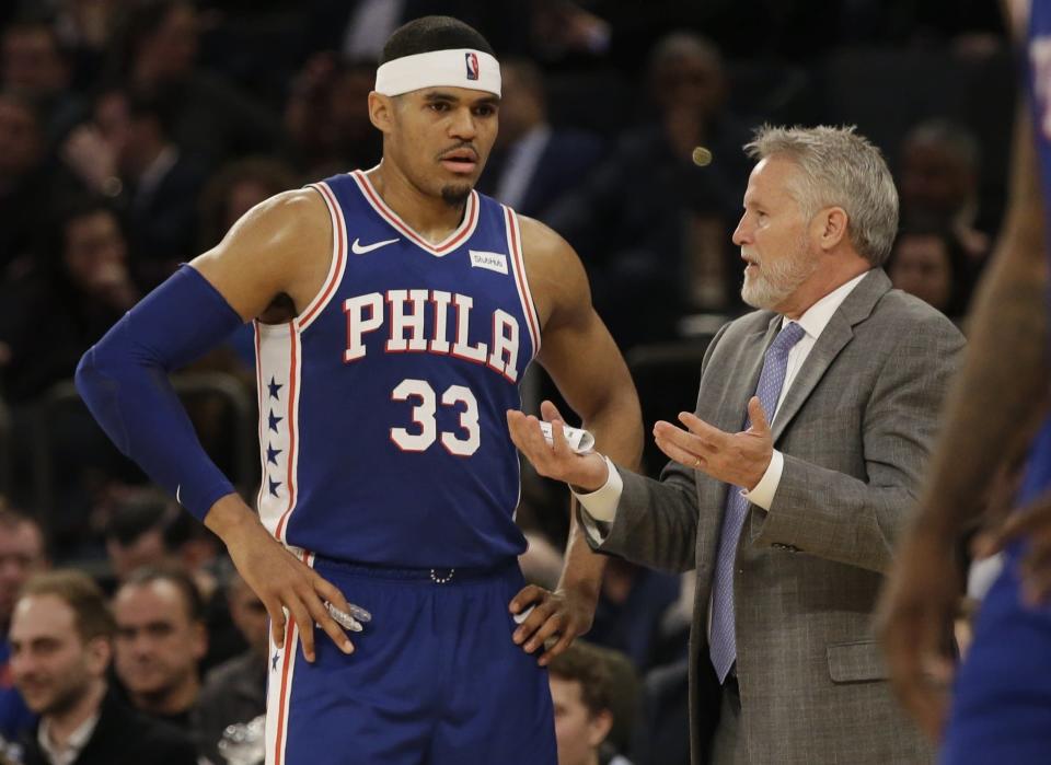 Philadelphia 76ers head coach Brett Brown, right, talks to Tobias Harris during the second half of an NBA basketball game against the New York Knicks, Wednesday, Feb. 13, 2019, in New York. The 76ers won 126-111. (AP Photo/Frank Franklin II)