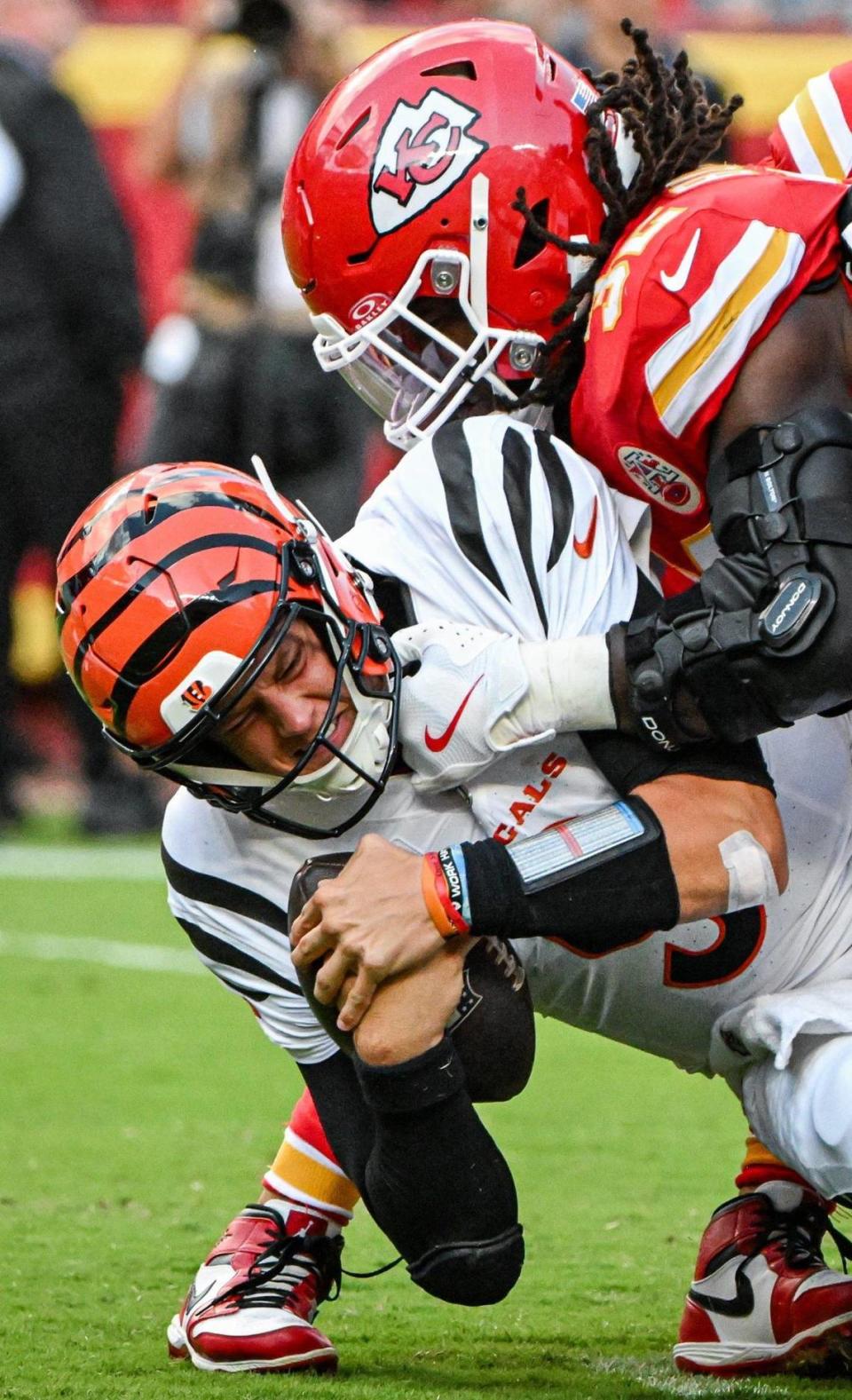 Kansas City Chiefs linebacker Nick Bolton (32) sacks Cincinnati Bengals quarterback Joe Burrow (9) in the second half Sunday, Sept. 15, 2024, at GEHA Field at Arrowhead Stadium.