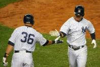 Oct 1, 2015; Bronx, NY, USA; New York Yankees right fielder Carlos Beltran (36) high fives second baseman Robert Refsnyder (64) on his home run during the eighth inning against the Boston Red Sox at Yankee Stadium. New York Yankees won 4-1. Anthony Gruppuso-USA TODAY Sports