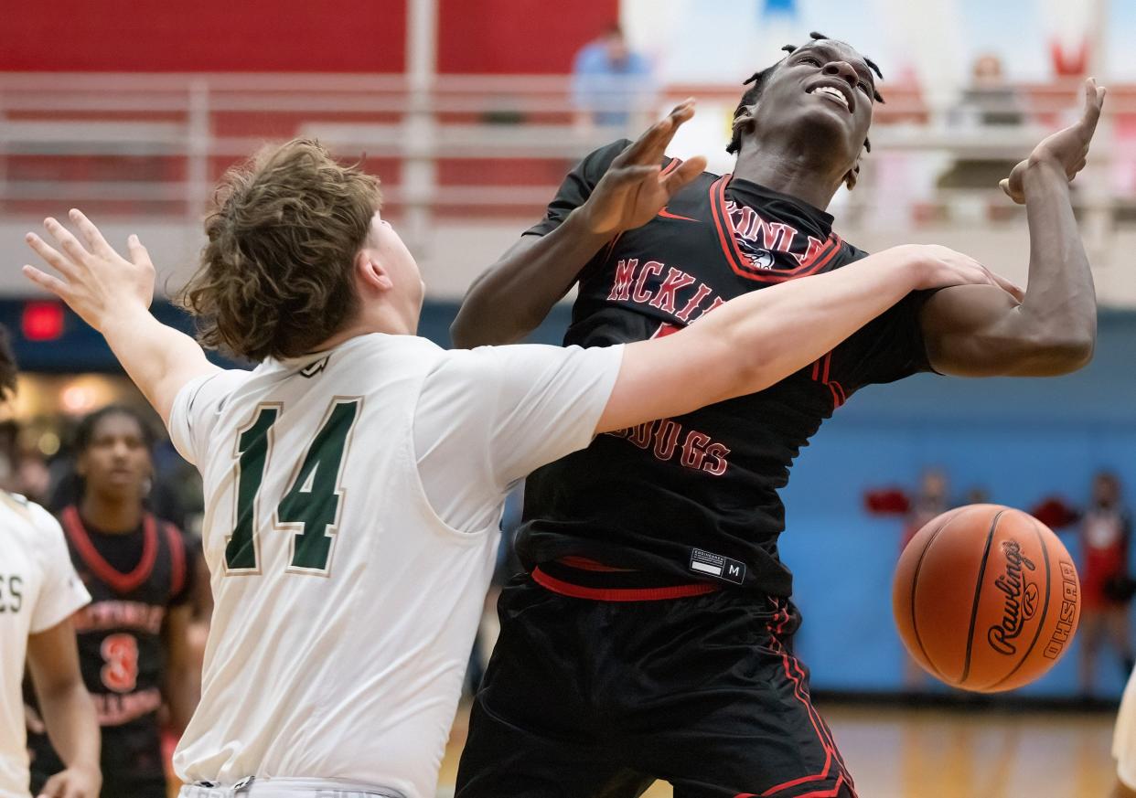 McKinley’s Je'Cis Moody is fouled by GlenOak’s Roman Woods during a district semifinal, Thursday, March 7, 2024.